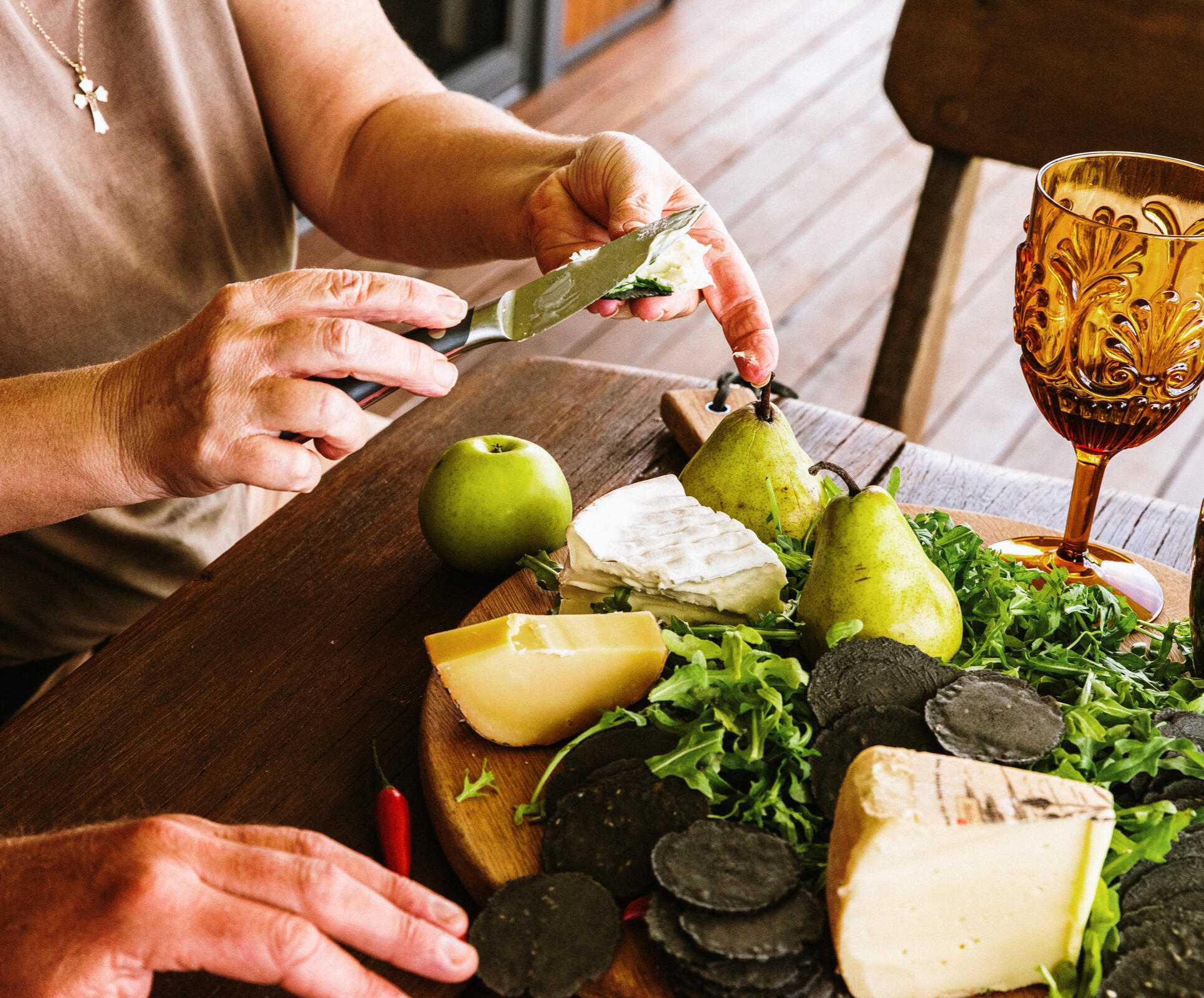 Guests enjoying local food and wine on the deck at Dorrigo Rainforest Retreat